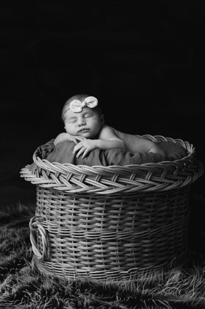 A mother and small child photographed close together in soft studio light